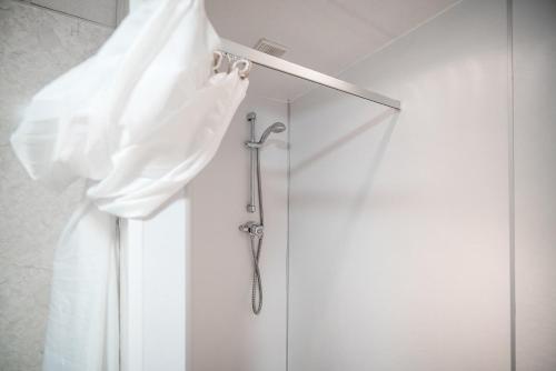 a shower curtain is hanging in a shower stall at Inverness Youth Hostel in Inverness