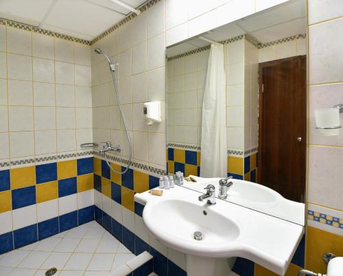 a bathroom with a sink and a shower at Kaliopa Hotel in Albena