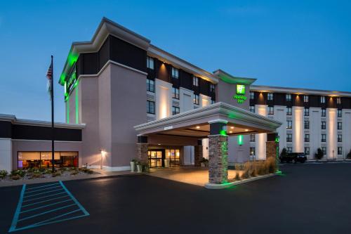 a hotel with a parking lot in front of it at Holiday Inn Milwaukee Riverfront by IHG in Milwaukee