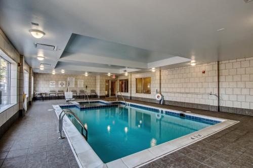 a swimming pool with blue water in a building at Holiday Inn Express & Suites Wytheville, an IHG Hotel in Wytheville