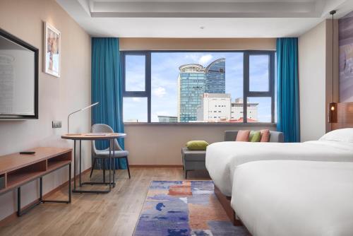 a hotel room with a bed and a window at Aurea Central Hotel in Phnom Penh