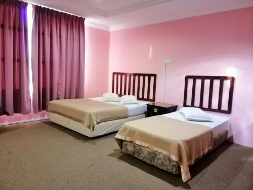 Tempat tidur dalam kamar di Hotel Nawar