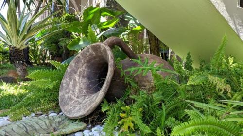 a garden with a toilet in the middle of plants at Lharmonie Villa in Pereybere