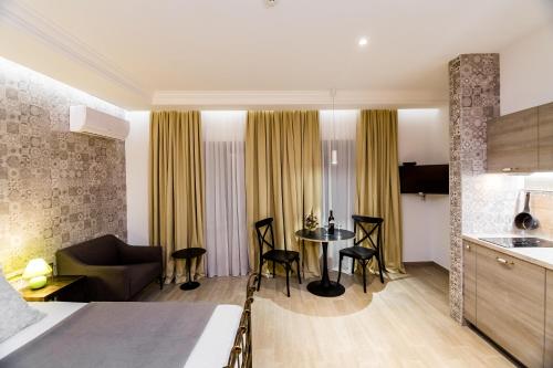 a kitchen and a living room with a table and chairs at Boutique Apart Upe in Tbilisi City