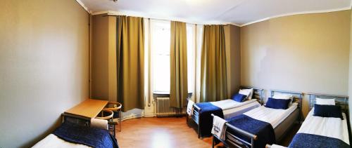 Postel nebo postele na pokoji v ubytování Sundsvall City Hotel