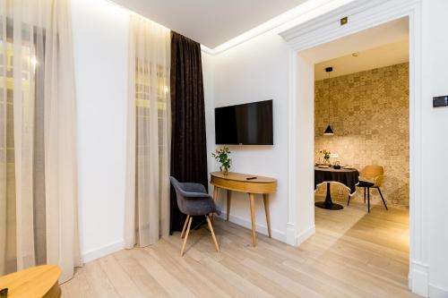 a living room with a table and a chair at Boutique Apart Upe in Tbilisi City