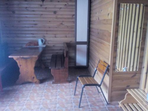 a bathroom with a sink and a wooden wall at Эко отель и баня in Kosharishche