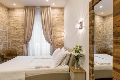 a hotel room with a bed and a window at Pellegrini Luxury Rooms in Split