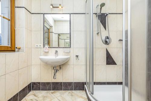 a bathroom with a shower and a sink at Appartement Oberreiter in Flachau