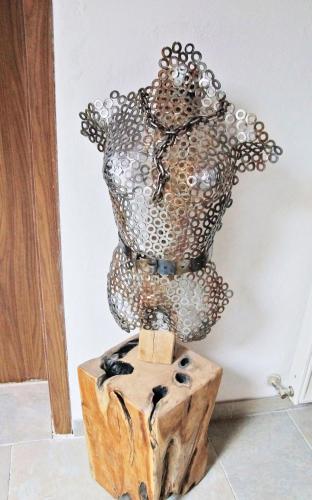a metal vase sitting on top of a wooden block at Alpengasthof Krische in Murau