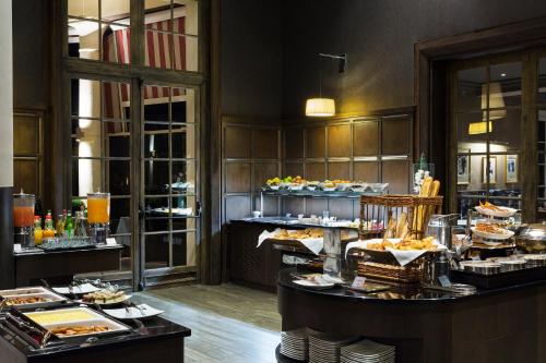 a buffet in a hotel room with food on display at Hôtel Barrière L'Hôtel du Golf in Deauville