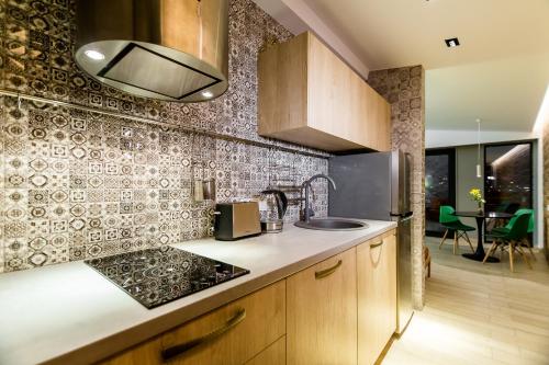 a kitchen with a sink and a counter top at Boutique Apart Upe in Tbilisi City