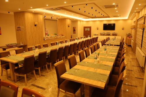 a large room with long tables and chairs at Oytun Park Hotel in Canakkale