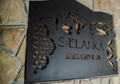a sign for a seshakka apartmentery and spa at Sielanka Apartamenty SPA in Białka Tatrzanska