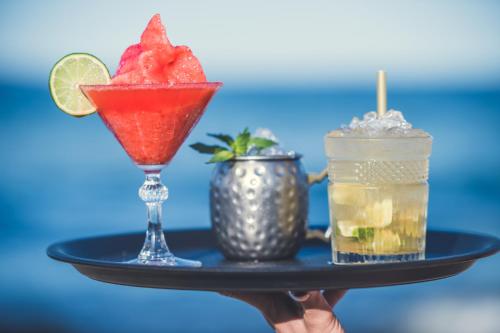 a tray with two cocktails and a drink at Apartments Oasis VIP Club in Sunny Beach