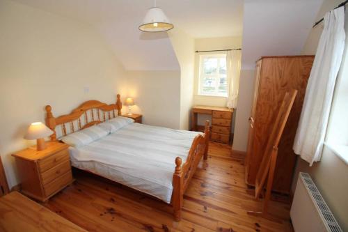 A bed or beds in a room at Rathmullan Holiday Homes