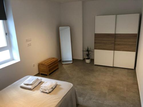 a bedroom with a bed with two towels on it at Apartamento Gran Teatro Falla-La Caleta in Cádiz