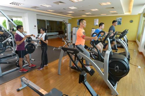 a group of people exercising on treadmills in a gym at Holiday Inn Melaka by IHG in Melaka