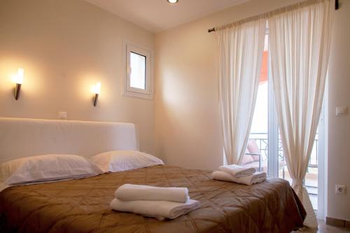 a bedroom with a bed with two towels on it at Villa Anna in Athani