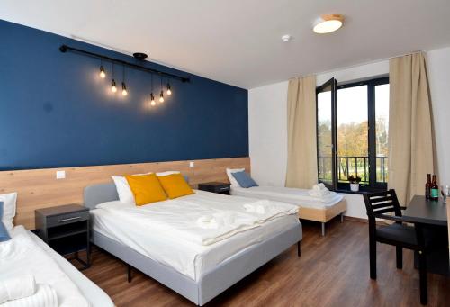 Ένα ή περισσότερα κρεβάτια σε δωμάτιο στο Ludwig Hotel