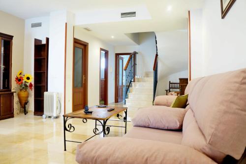 a living room with a couch and a table at Dúplex Centro Parking Ronda in Ronda
