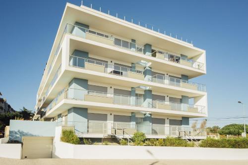 an apartment building with balconies on a beach at Clerigo - By SCH in São Martinho do Porto