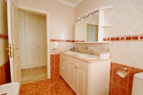a bathroom with a sink and a mirror and a toilet at Cozy Townhouse With Ocean Views in Costa Adeje in Adeje