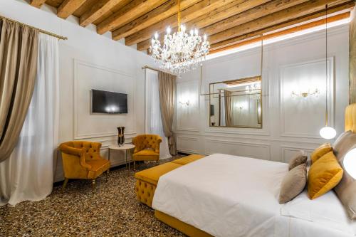 a bedroom with a large bed and a chandelier at Ca' Pagan in Venice