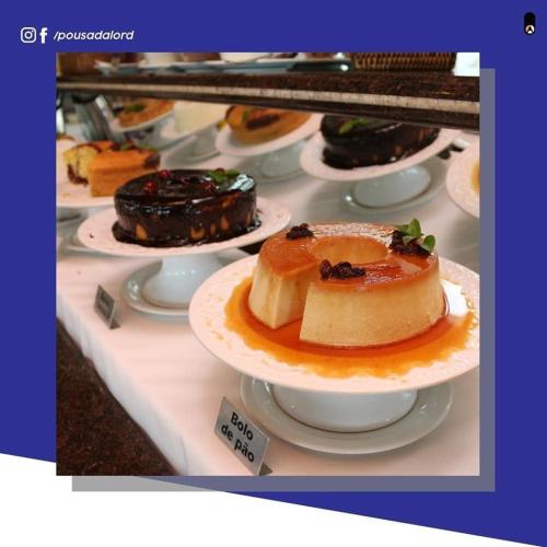 a display of different types of desserts on plates at Hotel Pousada Lord in Teixeira de Freitas