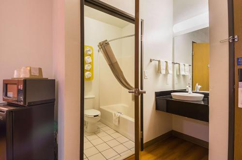 a bathroom with a sink and a toilet at Motel 6 Dallas – Irving DFW Airport South in Irving