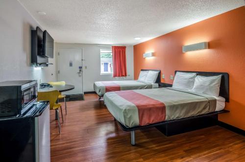 a hotel room with two beds and a television at Motel 6-Troutville, VA in Troutville