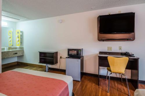 a room with a bed and a flat screen tv at Motel 6-Troutville, VA in Troutville