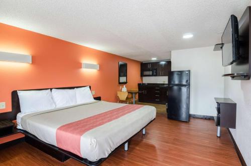 a hotel room with a bed and a kitchen at Motel 6-Troutville, VA in Troutville