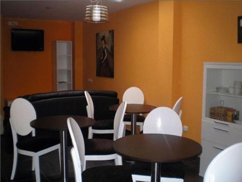 a room with tables and chairs and a couch at Rincón de Gala in Soria