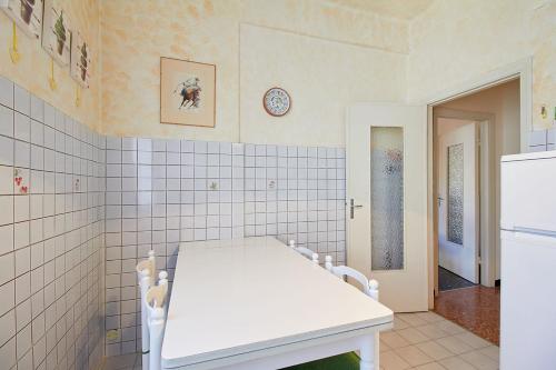 a kitchen with a white table and a white refrigerator at Borgomare in Finale Ligure