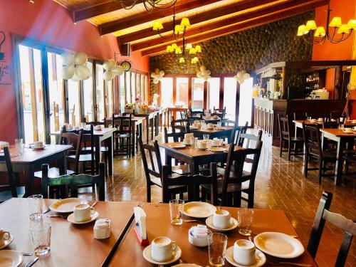 Kalken Hotel by MH في إل كالافاتي: غرفة طعام مع طاولات وكراسي في مطعم