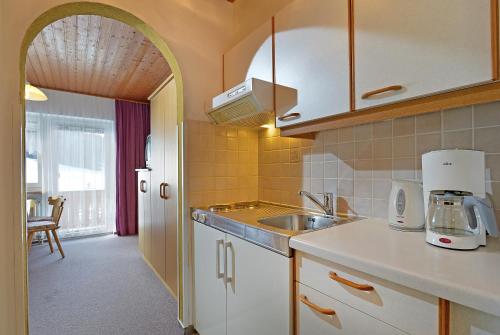 a kitchen with a sink and a counter top at Haus Gratz in Söll