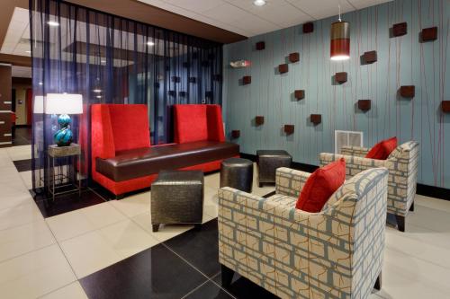 a waiting room with two chairs and a bench at Holiday Inn Express & Suites Northeast by IHG in York