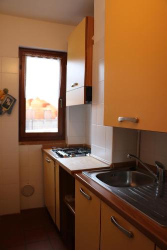 a small kitchen with a sink and a window at Residence Weissthor in Macugnaga