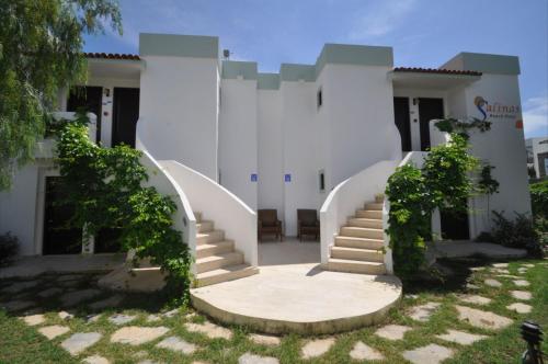 a white building with stairs in front of it at Salinas Hotel in Gümbet