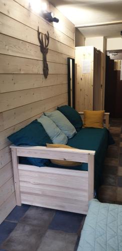 a bedroom with a bed in a wooden wall at Résidence le Galaxie in Villard-de-Lans