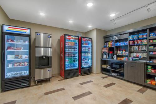 a store with two refrigerators and a television in a room at Candlewood Suites - San Antonio Lackland AFB Area by IHG in San Antonio