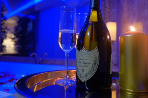 a bottle of wine and a glass on a table at Central Business Apartments Jacuzzi in Belgrade