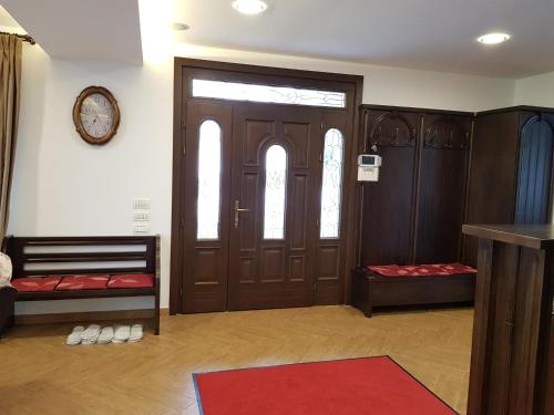 a room with wooden doors and a red rug at Casa Aryana, adults only in Bran
