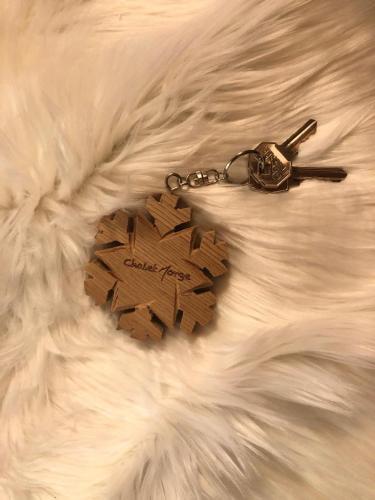 a key chain with a heart on a white blanket at Chalet Morge in La Salle