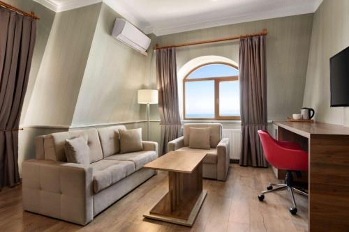 a living room with a couch and a table at Ramada by Wyndham Van in Van