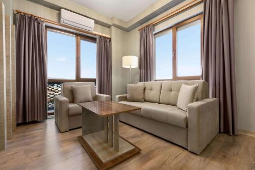 a living room with a couch and a table at Ramada by Wyndham Van in Van