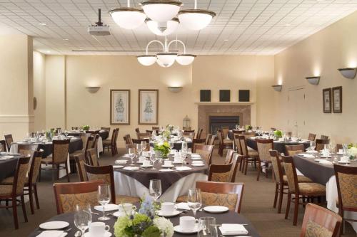 a banquet room with tables and chairs and a fireplace at Ivey Spencer Leadership Centre in London