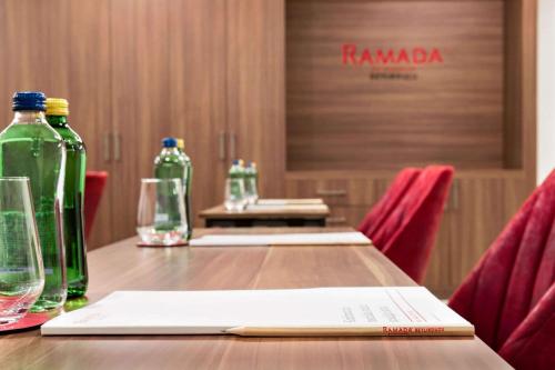 a wooden table with two bottles and a book at Ramada by Wyndham Beylikduzu in Istanbul