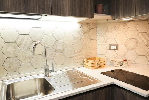 a kitchen with a sink and a counter top at Una Chicca a Roma in Rome